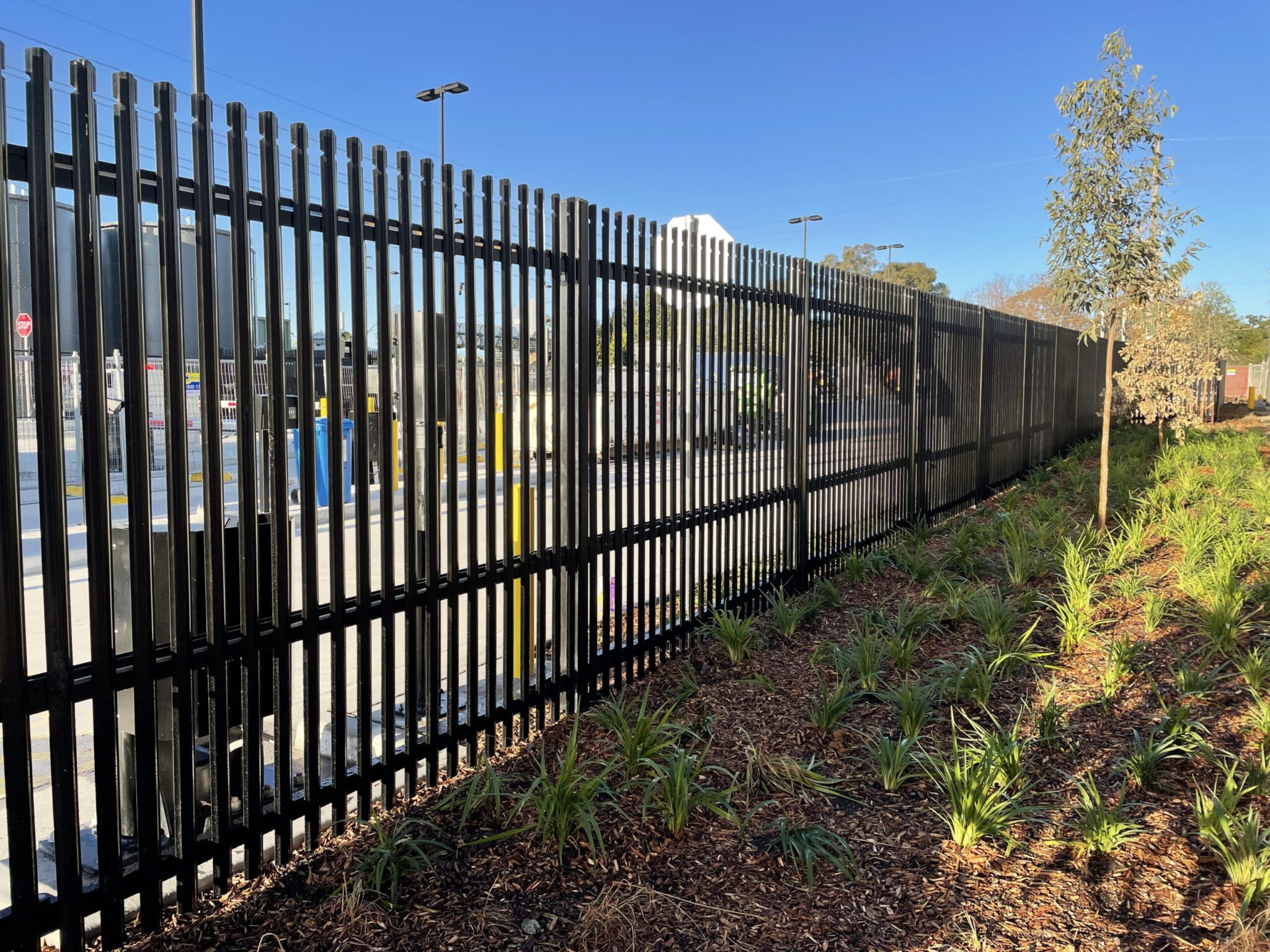 RJL Commercial Fencing and Gates — 358 mesh fencing with razor coil topping protecting a rail stabling yard